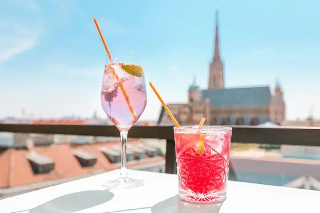 cocktails on a rooftop terrace in vienna in summer overlooking the famous stephens church in vienna