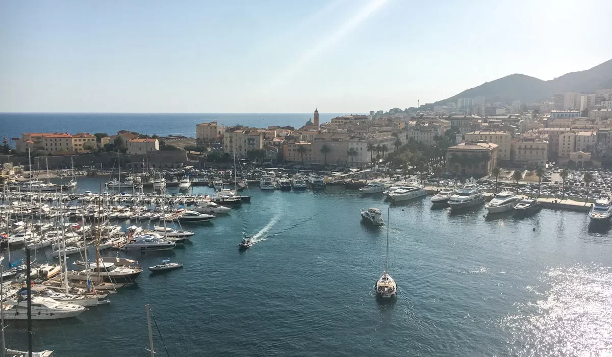 Stunning picture of Ajaccio marina and cruise port from a high vantage point with lovely houses and mediterranean sea in the background