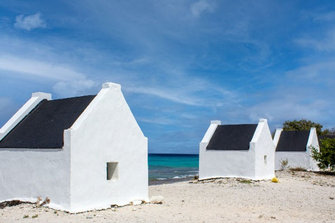 white former slave houses of bonaire in front of ocean