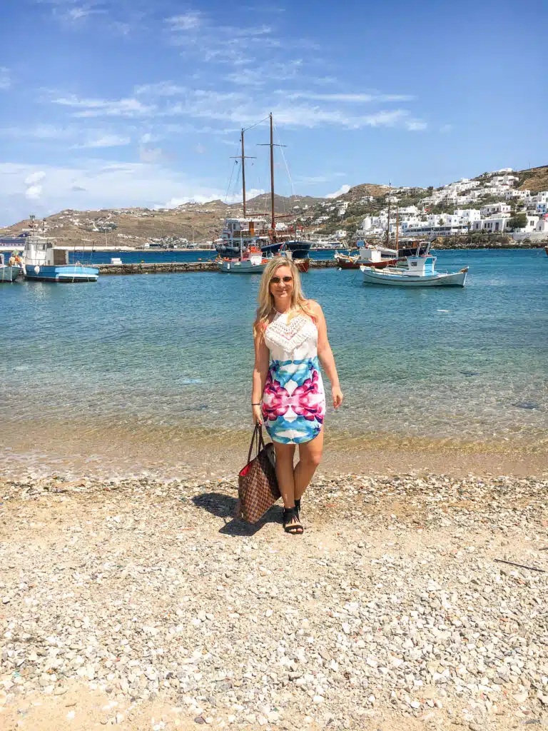 the author in a sundress on  a beach in mykonos
