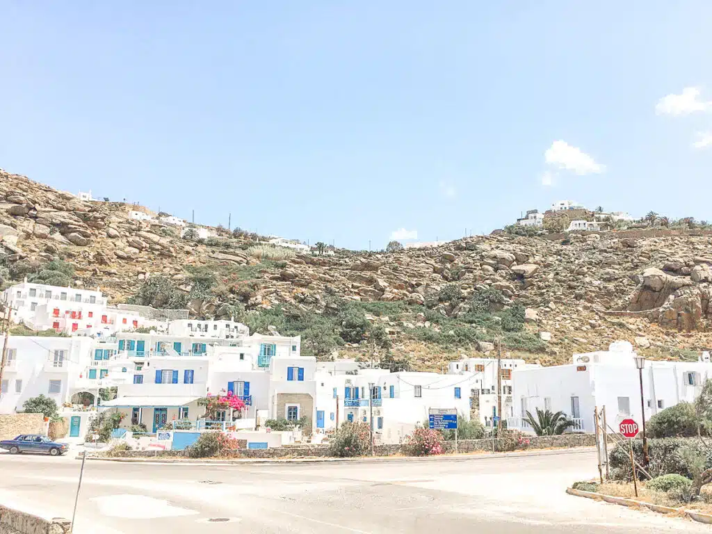 picture of a small street with white houses in mykonos