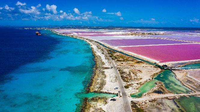 A drone picture showing the pink lakes and ocean of bonaire as well as the salt mines of bonaire