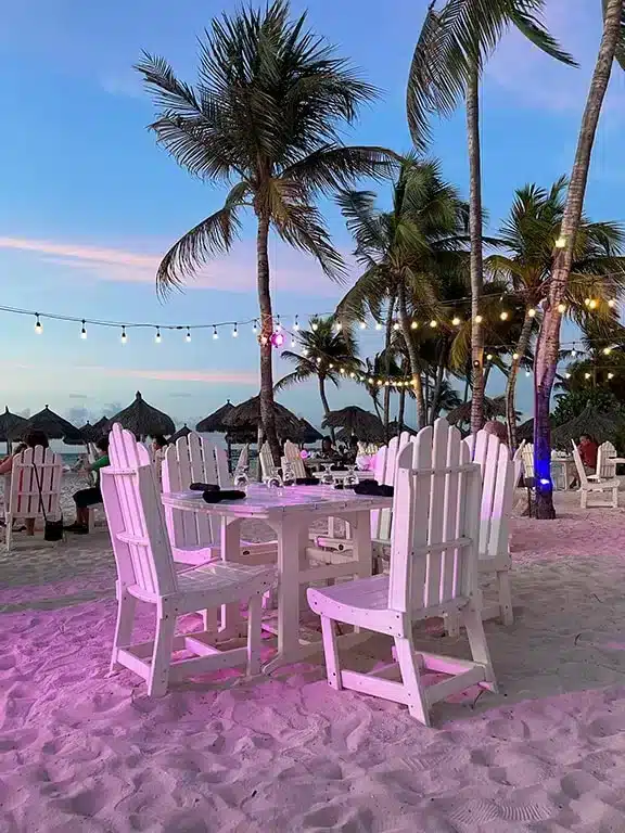Expensive beachfront restaurant in Aruba, nicely set table in the evening in the beach