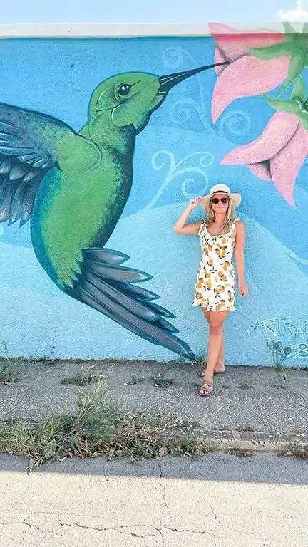 picture of the author's wife in aruba posing next to a mural
